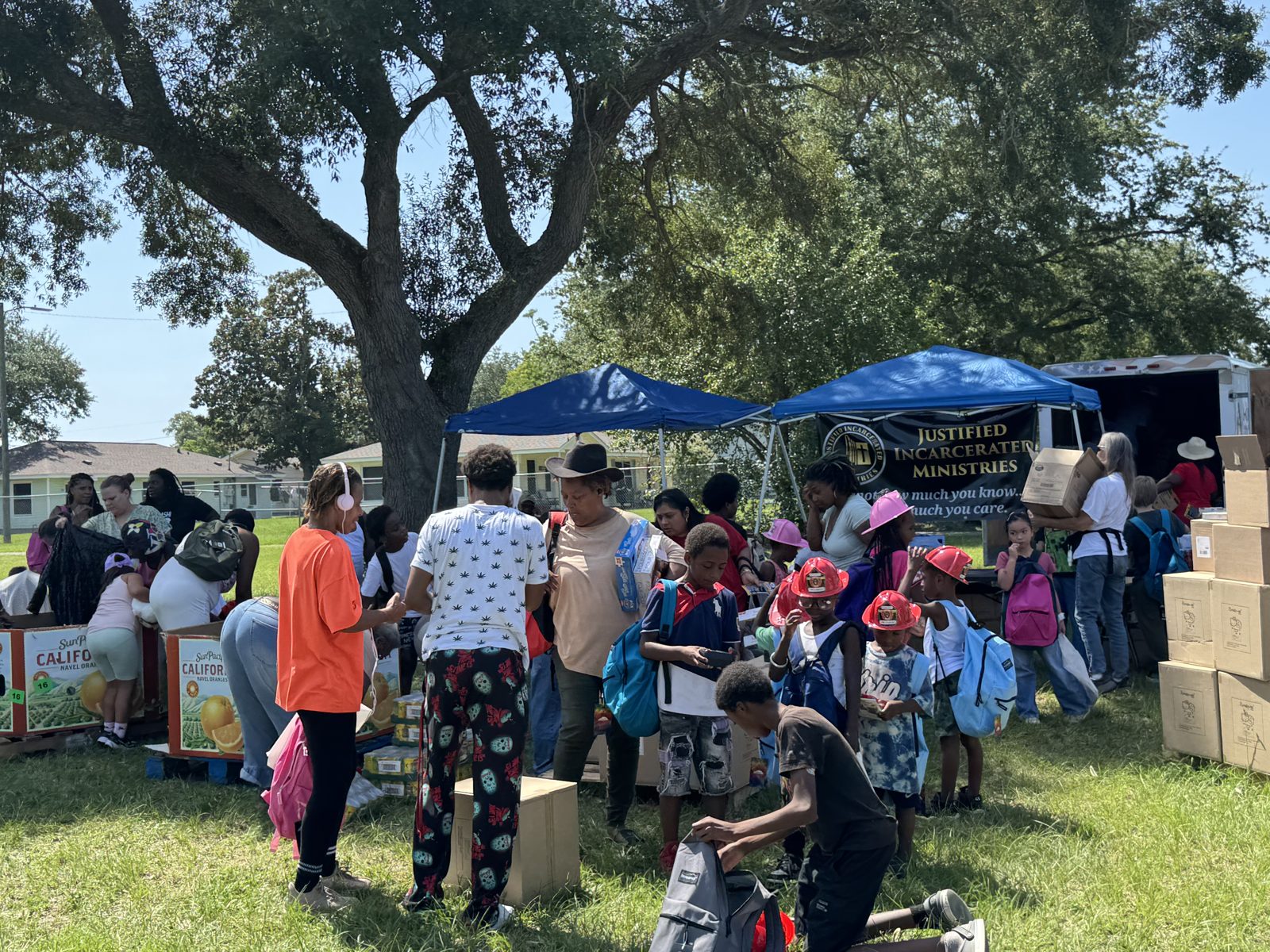 Families picking up backpacks and school supplies at the PCS Outreach Ministries back-to-school event