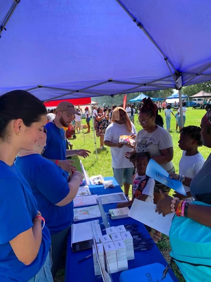Taylor Dental team members handing out supplies at the PCS Outreach Ministries back-to-school event in Pensacola